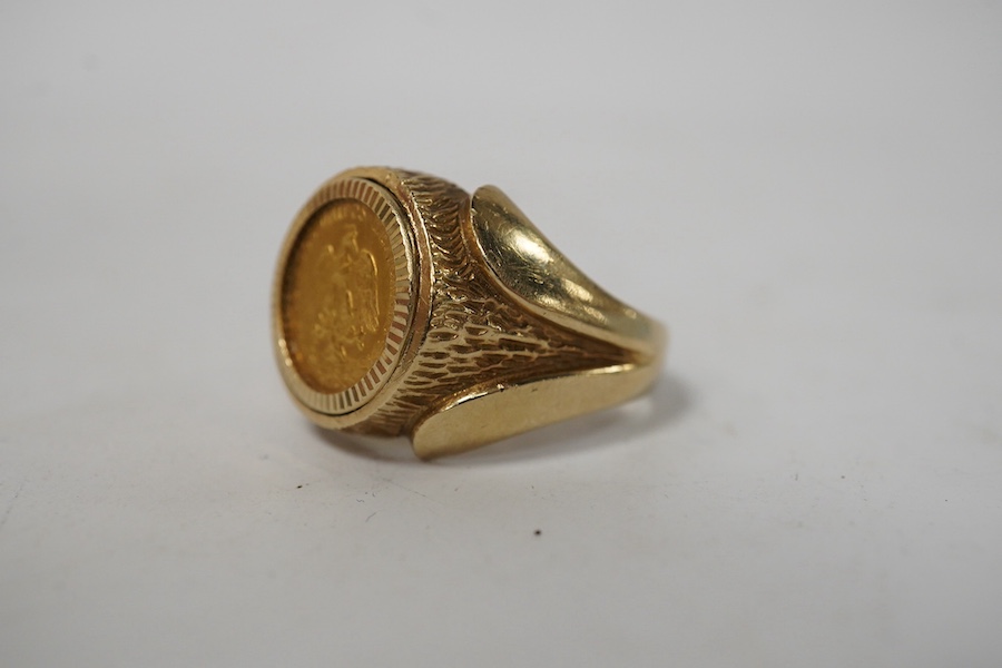 A 9ct gold ring set with a gold Mexican Two Peso coin, size R1/2, British hallmarks, gross weight approximately 9 grams. Condition - good, some scratches